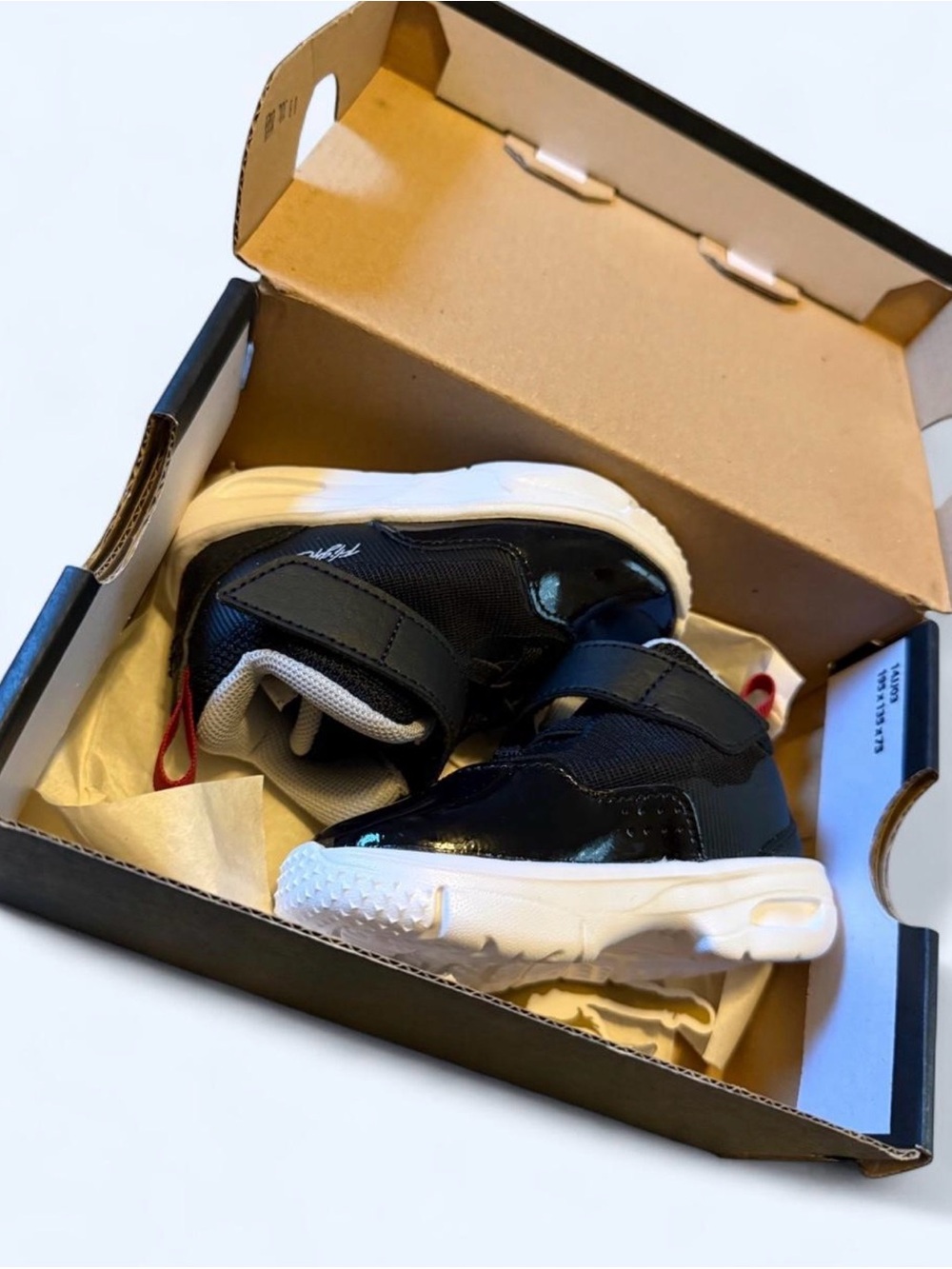 Jordan Kids Black and White High-Top Sneakers with Red Accent